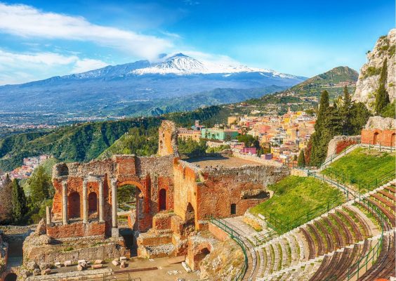 Greek theatre of Taormina with snow-capped Mt. Etna in the background