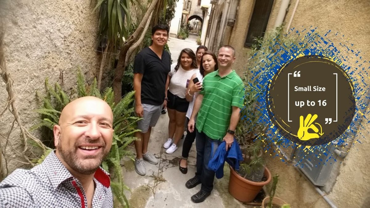 Vincenzo with a small group tour of travelers in a Sicilian alley